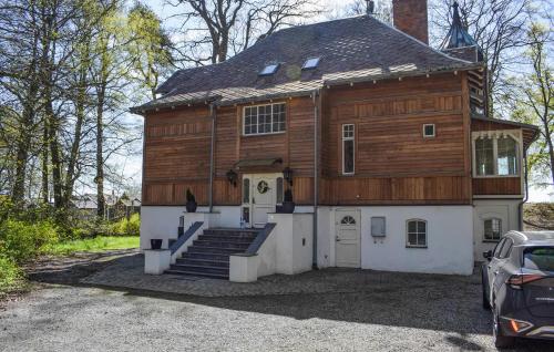 a large wooden house with stairs and a garage at Villa Sommarro in Ystad