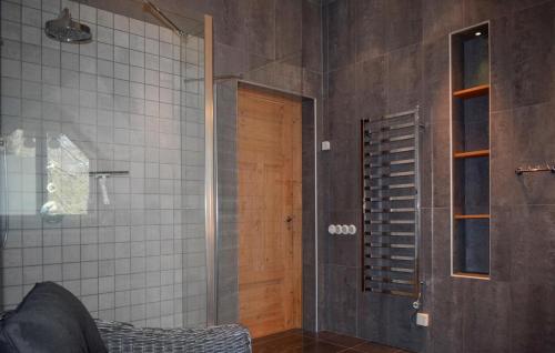 a bathroom with a walk in shower and a glass door at Villa Sommarro in Ystad