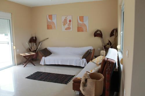 a living room with a bed and a couch at Villa Aphrodity in Kos Town