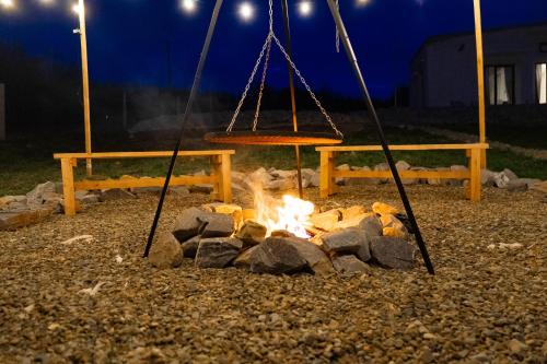 a fire pit with a swing and afire at Bunkier House in Niedźwiada