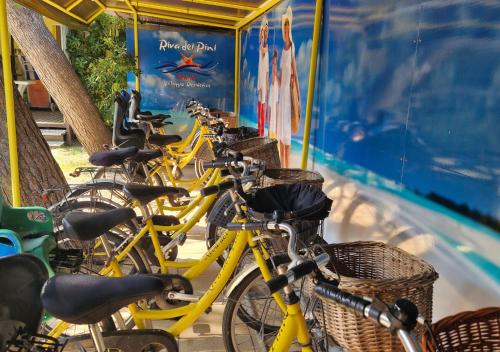 a row of bikes parked next to a train at FAMILY KIDS VILLAGE Riva dei Pini in Lido di Fermo