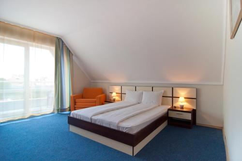 - une chambre avec un lit, une chaise et une fenêtre dans l'établissement Guest House Hiora, à Ahtopol