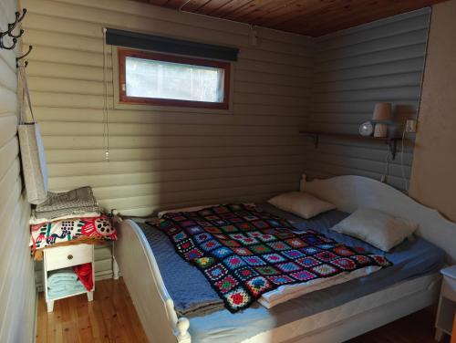 a bedroom with a bed in a room at Ahlaistentupa in Pori