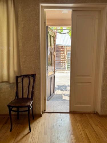 an open door with a chair in a room at Private House , in the middle of the city, in 10 min. To Fabrika in Tbilisi City