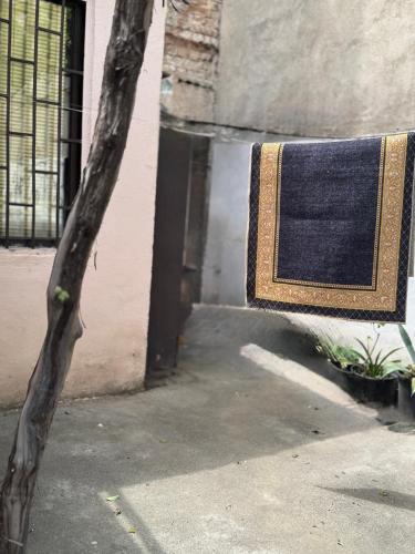 a rug hanging on the side of a building at Private House , in the middle of the city, in 10 min. To Fabrika in Tbilisi City