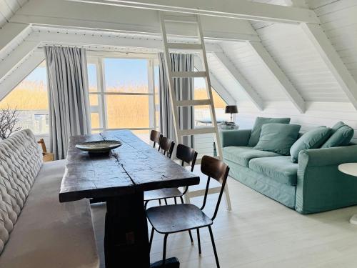 a living room with a table and a couch at Seehütte Neusiedlersee inklusive Boot in Rust