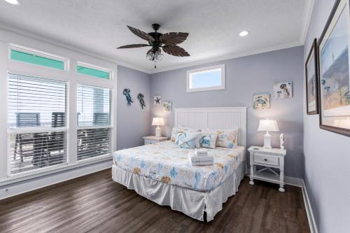 a bedroom with a bed and a ceiling fan at Blessed 4 Shore Beachfront 4B in Gilchrist