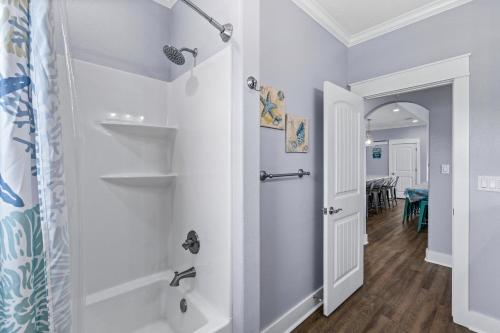 a bathroom with a shower and a walk in closet at Blessed 4 Shore Beachfront 4B in Gilchrist