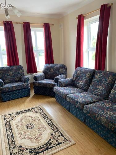 a living room with a couch and two chairs at Cranagh House, Kinvara. in Loughcurra