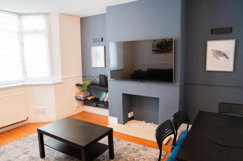 a living room with a fireplace with a flat screen tv at Berry Mansions - Comfort & Style in Wyken