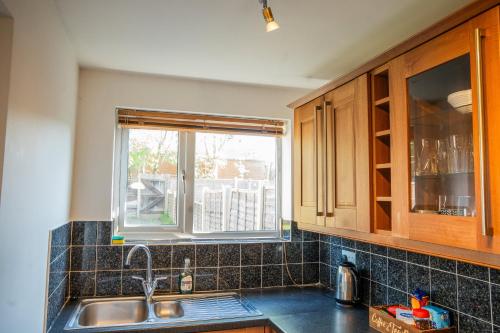 a kitchen with a sink and a window at Berry Mansions - Comfort & Style in Wyken