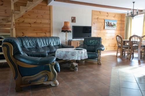 a living room with a couch and a table at Dom pod Lipą in Jaminy