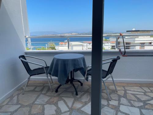 a table and two chairs in front of a window at Teras in Seferihisar