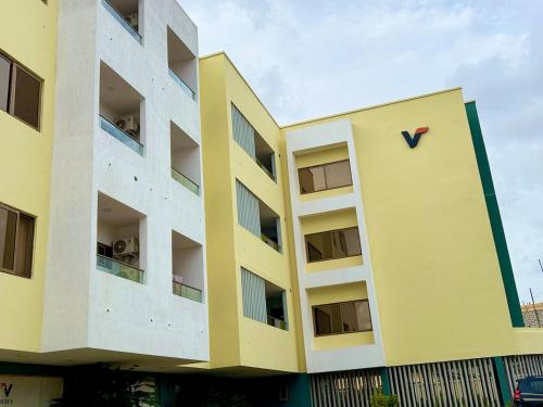 a building with a clock on the side of it at Cozy & Modern Stays in Trofwi