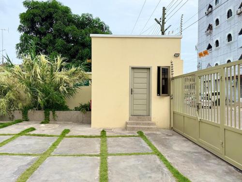 a house with a gate and a door at Cozy & Modern Stays in Trofwi