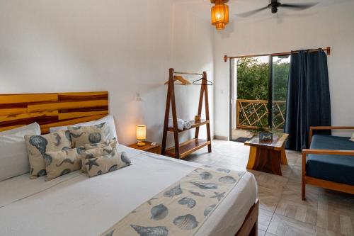 a bedroom with a large bed and a window at Casa Cuyo Hotel in El Cuyo