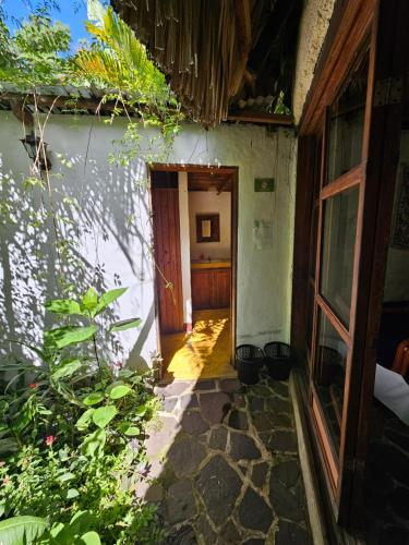 an entrance to a house with a door open at Hotel La Paz in San Pablo La Laguna