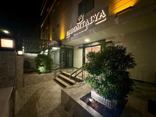 a building with a sign on the side of it at Bloomtalya Hotel in Antalya