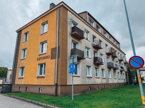 a large building with balconies on the side of it at Apartament Keja Olecko in Olecko