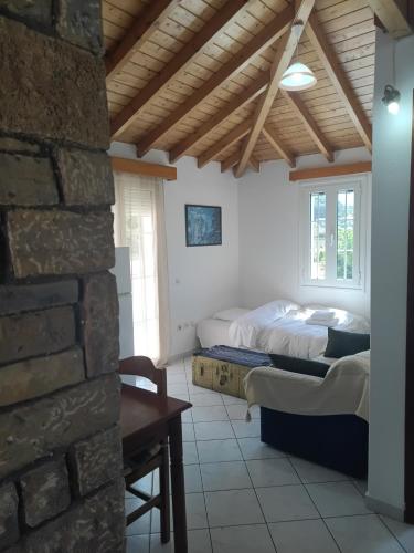 a bedroom with two beds and a brick wall at Eva's Apartments in Karlovasi
