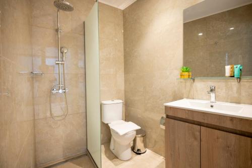 a bathroom with a shower and a toilet and a sink at Diamond Apartments 1 in Kardamaina