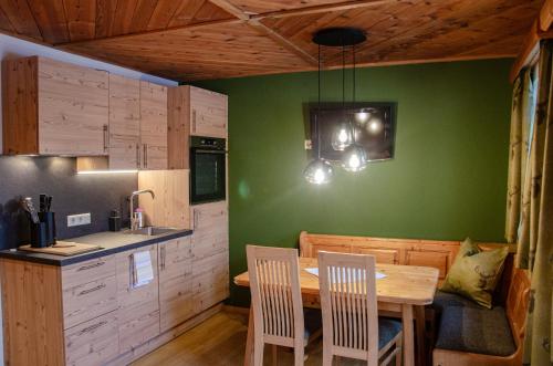 a kitchen and dining room with a table and chairs at Stoanerhof in Schladming