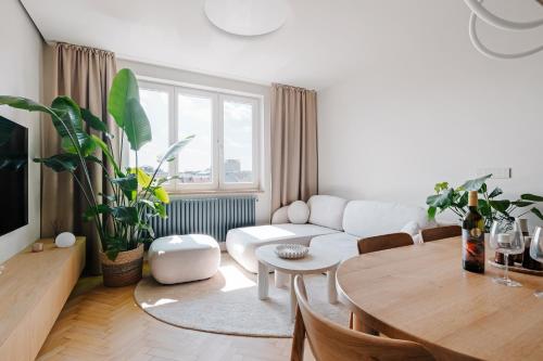 a living room with a white couch and a table at BeComfy - Old town apartment Bratislava in Staré Mesto