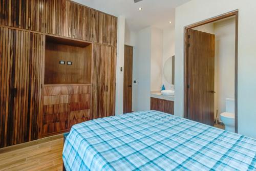 a bedroom with a bed and a bathroom with a toilet at Amazing 2 bedrooms apartment with a pool in Sayulita in Sayulita