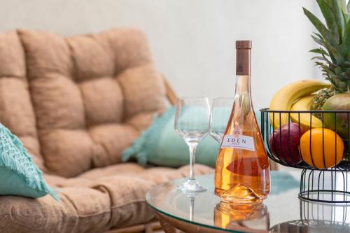 a bottle of wine and two glasses on a table at Diamond Apartments 1 in Kardamaina