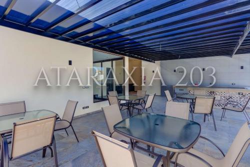 a room with tables and chairs and a sign at Amazing 2 bedrooms apartment with a pool in Sayulita in Sayulita