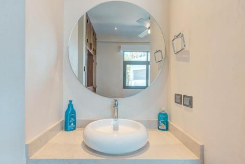 a bathroom with a sink and a mirror at Amazing 2 bedrooms apartment with a pool in Sayulita in Sayulita