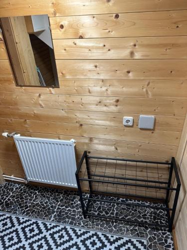 a room with a wooden wall with a bench and a mirror at Ferienwohnungen Hatzl in Neuwald