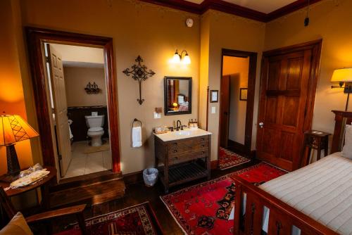 a bedroom with a bathroom with a sink and a toilet at Gifford-Risley House Bed and Breakfast in Media