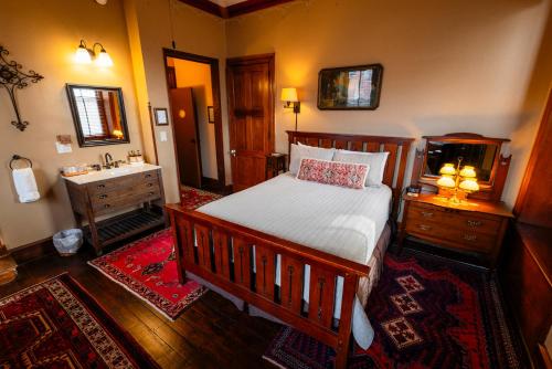 a bedroom with a bed and a sink in it at Gifford-Risley House Bed and Breakfast in Media