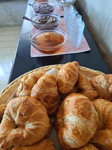 a basket filled with croissants on top of a table at Hotel Atlantis in Corfu Town