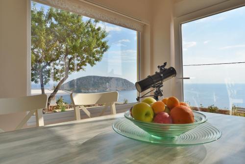 a bowl of fruit on a table with a camera at Casa Arsida in Anavissos