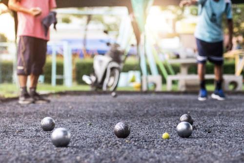 a group of balls on the ground with two people at Guadeloupe 5 Étoiles Front de Mer Rénové 2025 in Saint-François