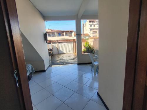 a view from a door of a room with a balcony at Temporada em Piúma in Piúma