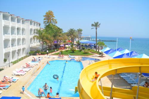 a pool at a resort with people in the water at Club Hotel Rama in Beldibi