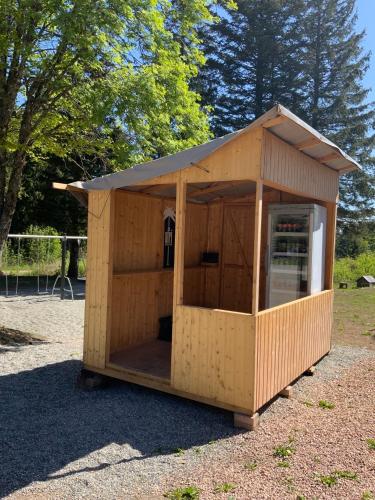 a wooden shed with a window in a park at Naturfreundehaus Brend in Neuweg