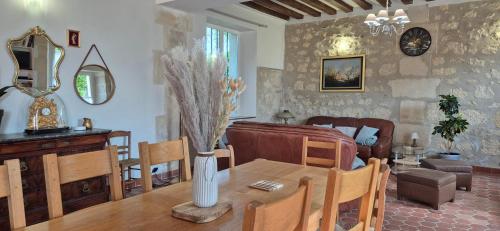 un salon avec une table et une salle à manger dans l'établissement Domaine de la Ferme de Tumbrel, à Neuville-Bosc