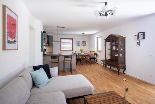 a living room with a couch and a kitchen at Haus Malina in Sankt Michael ob Bleiburg