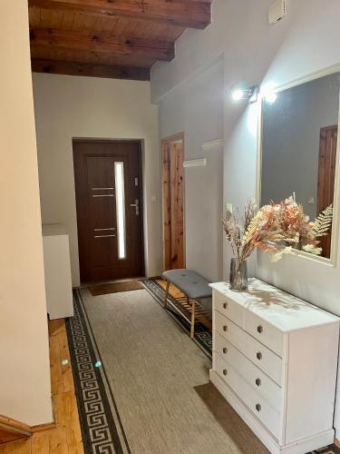 a room with a white dresser and a mirror at Wigierska Osada 1 in Danowskie