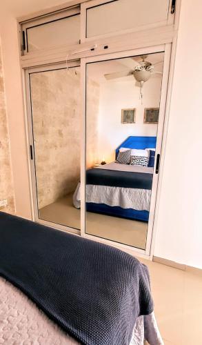 a bedroom with a large mirror in front of a bed at Vista paraiso in La Puntica de Juan Dolio
