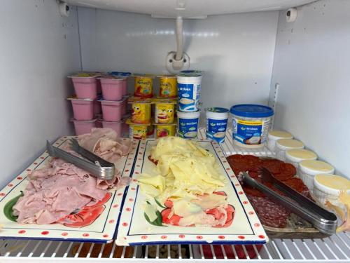 a refrigerator filled with different types of food and drinks at Pousada Vila Canoa in Canoa Quebrada