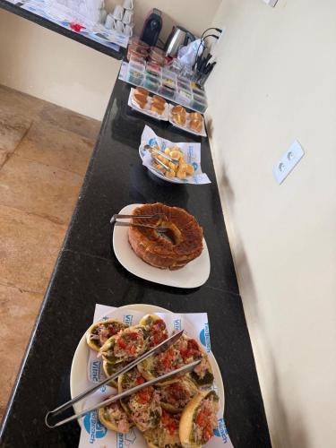 a table with two plates of food on it at Pousada Vila Canoa in Canoa Quebrada