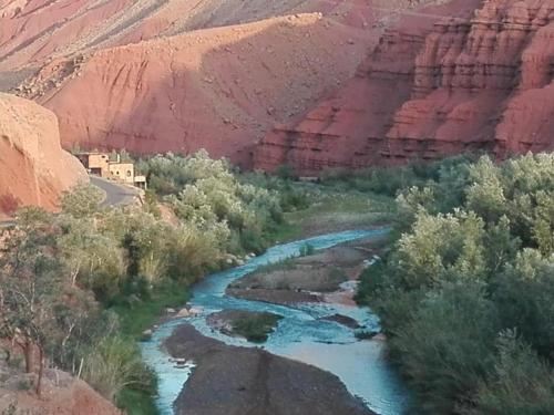 a river in the middle of a canyon at Gite d'étape Tafsoute in Tameskikt