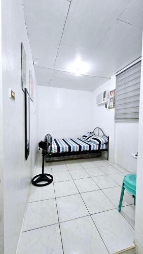 a room with a bed and a table in it at Happy Homes Guest House in Legazpi