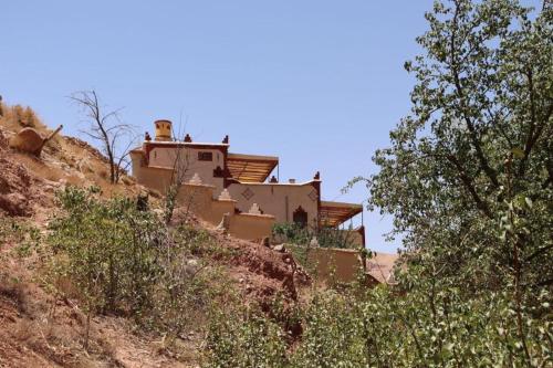a house on the side of a hill at Gite d'étape Tafsoute in Tameskikt