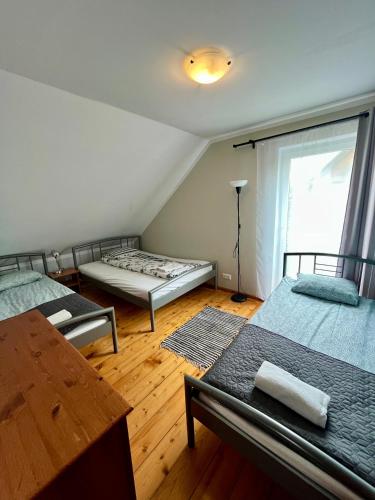 a room with two beds and a window at Wigierska Osada in Danowskie